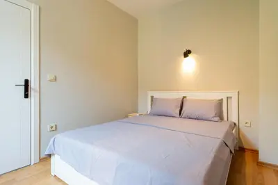 a bedroom with a white bed with a light above it at Lovely and Snug Flat, Just Steps from Istiklal Street in Istanbul