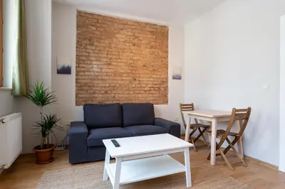 a living room with a blue couch and a table at Lovely and Snug Flat, Just Steps from Istiklal Street in Istanbul