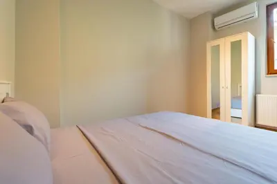 a white bedroom with a bed and a window at Lovely and Snug Flat, Just Steps from Istiklal Street in Istanbul