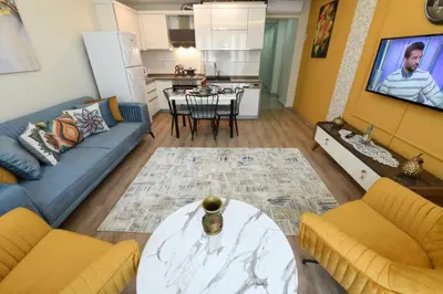 a living room with a couch and a table and a kitchen at Space Apartments in Istanbul