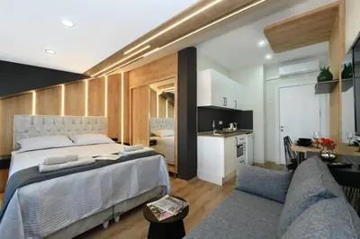 a bedroom with a large bed and a kitchen at Space Apartments in Istanbul