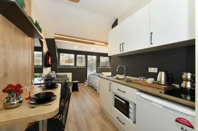 a kitchen with white cabinets and a wooden counter top at Space Apartments in Istanbul