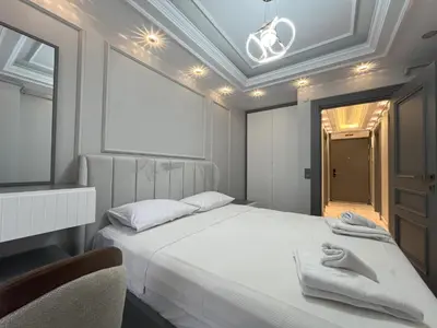 a bedroom with a white bed with towels on it at Ruzi's House in Istanbul