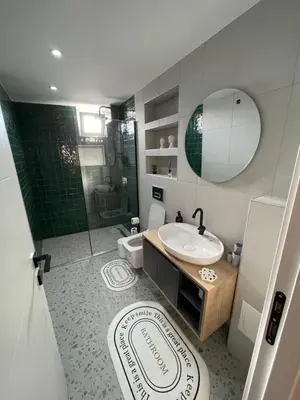a bathroom with a sink and a shower and a toilet at Golden Arrow delüx Dublex in Istanbul