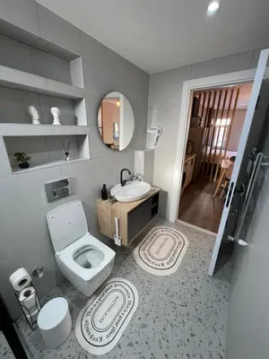 a bathroom with a toilet and a sink and a mirror at Golden Arrow delüx Dublex in Istanbul
