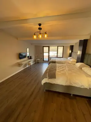a bedroom with a large bed and a wooden floor at Golden Arrow delüx Dublex in Istanbul