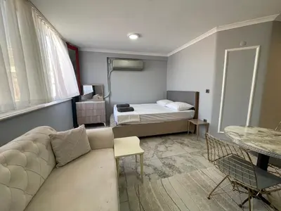 a living room with a couch and a bed at Family House in Istanbul