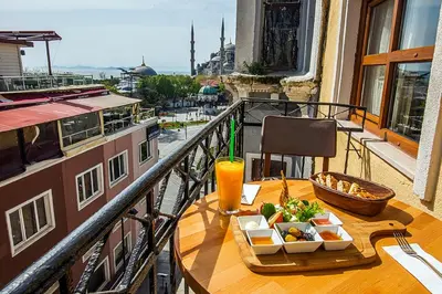 a table with a tray of food and a drink on a balcony at Million Old City Apartment in Istanbul