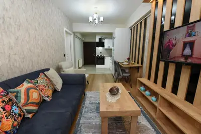 a living room with a blue couch and a table at Bomonti Apartments in Istanbul