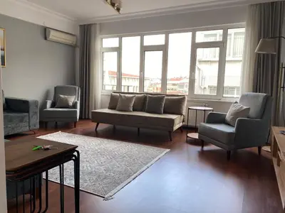 a living room with a couch and two chairs and a table at Fully Renovated apartment in Istanbul