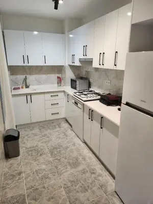 a kitchen with white cabinets and white appliances at Fully Renovated apartment in Istanbul