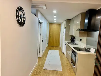 a kitchen with white cabinets and a clock on the wall at İstanbul buluşma noktası in Istanbul