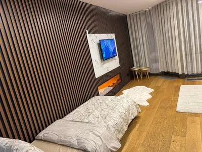 a bedroom with a bed and a tv on a wall at İstanbul buluşma noktası in Istanbul