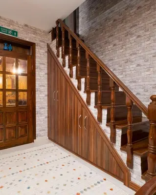 a wooden staircase in a home with a brick wall at Uludag Tatil Evleri & Villa Dogus Uludağ in Bursa