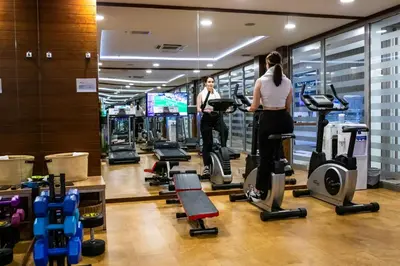 two women exercising on tread machines in a gym at Ramada Encore Istanbul Kartal in Istanbul