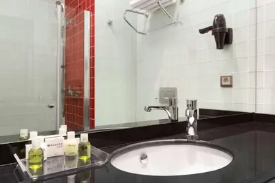 a bathroom with a sink and a mirror at Ramada Encore Istanbul Kartal in Istanbul