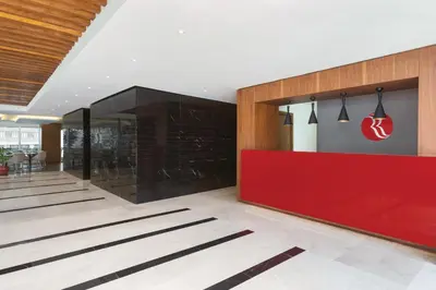 a lobby with a red counter in a building at Ramada Encore Istanbul Kartal in Istanbul