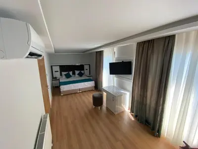a bedroom with a bed with blue pillows at Maritime Boutique Hotel in Istanbul