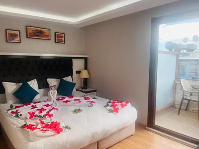 a bedroom with a large bed with red flowers on it at Maritime Boutique Hotel in Istanbul