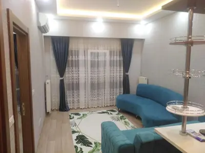 a living room with blue chairs and a couch at ميدوكليه بشاك شهير 1 in Istanbul
