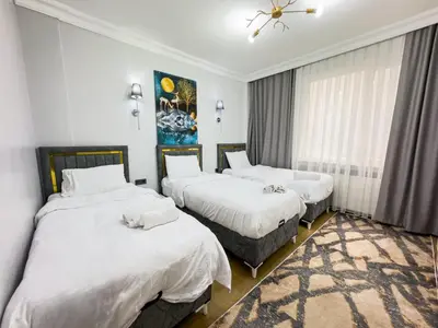 a bedroom with two beds and a painting on the wall at Sisli Holiday 4412 in Istanbul