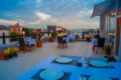 a patio with tables and chairs on a balcony at Sarnic Hotel & Sarnic Premier Hotel(Ottoman Mansion) in Istanbul