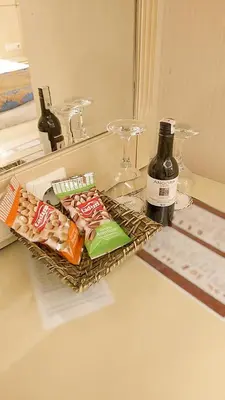 a counter top with snacks and a bottle of wine at Sarnic Hotel & Sarnic Premier Hotel(Ottoman Mansion) in Istanbul