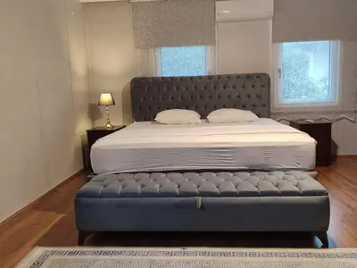 a bedroom with a bed with a tufted foot board at Kilyos Serendipity in Sarıyer