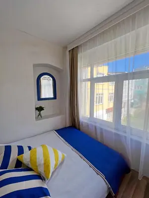 a bed in a room with a large window at Central 5 Bedroom 5 Bathroom, Newly Renovated Villa at the heart of the city in Istanbul