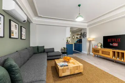 a living room with a couch and a tv at Respiro Rooms in Istanbul