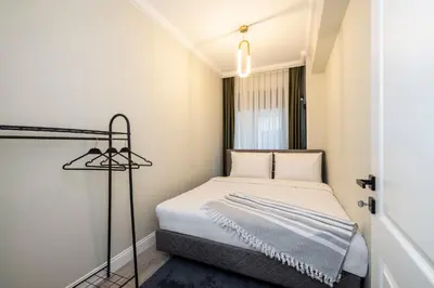 a small bedroom with a bed and a lamp at Respiro Rooms in Istanbul