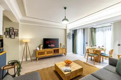 a living room with a couch and a tv at Respiro Rooms in Istanbul