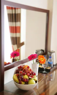 a bowl of fruit on a table in front of a mirror at Fimka Hotel in Istanbul