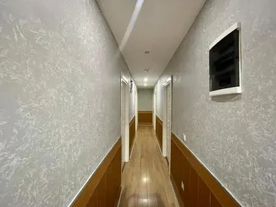 a hallway with a wall with a tv on it at Rozza Hotel in Istanbul