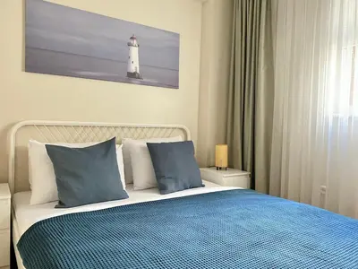 a bedroom with a bed with a lighthouse on the wall at Spacious & City Center 3 Bedroom Flat - No2 in Istanbul