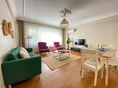 a living room with a green couch and a table at Spacious & City Center 3 Bedroom Flat - No2 in Istanbul