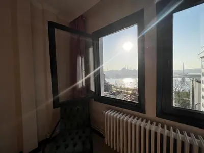 two windows in a room with a view of the city at Astounding Sea View Apartment in Karaköy 4BR, 2BA in Istanbul