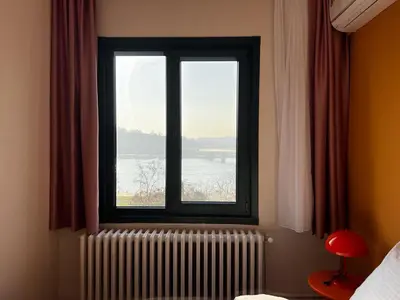 a window in a bedroom with a radiator at Astounding Sea View Apartment in Karaköy 4BR, 2BA in Istanbul