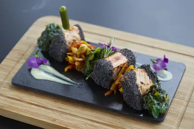 a black plate with some food on a table at Uranus Istanbul Topkapi in Istanbul
