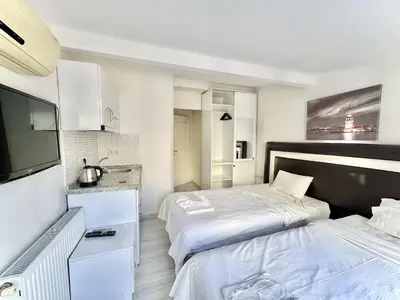 a bedroom with two beds and a flat screen tv at Taksim Seven Residence in Istanbul