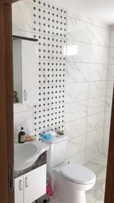 a white bathroom with a toilet and a sink at Rahat bahçeli polonezköyde butik evimiz in Beykoz