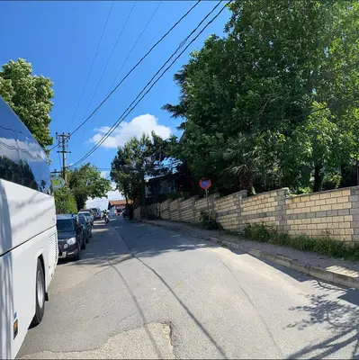 a bus is parked on the side of a street at Rahat bahçeli polonezköyde butik evimiz in Beykoz