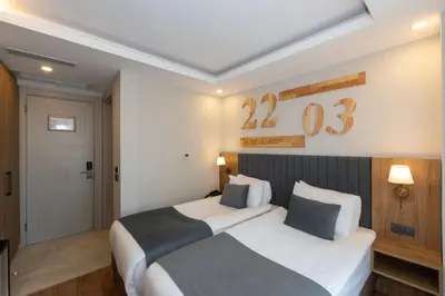 two beds in a hotel room with numbers on the wall at Harmony Hotel Istanbul & SPA in Istanbul