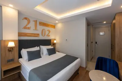 a bedroom with a bed and a table in a room at Harmony Hotel Istanbul & SPA in Istanbul