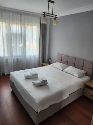 a bedroom with a large bed with two towels on it at KADIKOY merkezi konumda in Istanbul