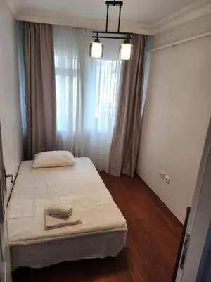 a bedroom with a large bed with a window at KADIKOY merkezi konumda in Istanbul
