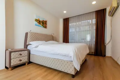 a bedroom with a large bed and a window at Algold in Istanbul