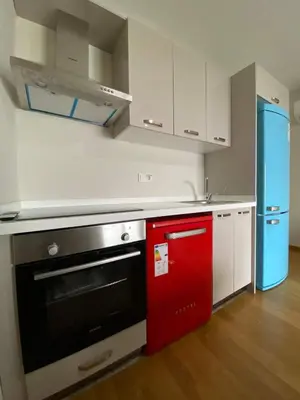 a kitchen with a red oven and white cabinets at Luxury Unit with Sea View Taksim Square in Istanbul