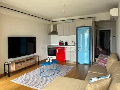 a living room with a couch and a kitchen at Luxury Unit with Sea View Taksim Square in Istanbul