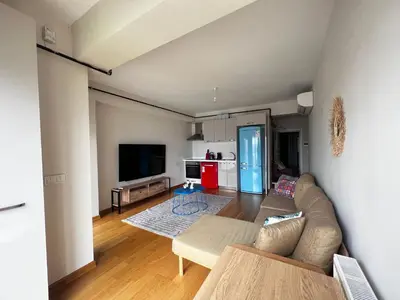 a living room with a couch and a kitchen at Luxury Unit with Sea View Taksim Square in Istanbul
